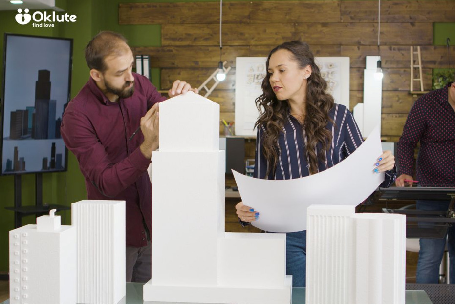 10 Unusual Architectural Wonders That Challenge Conventional Design Architects reviewing a model for an unusual building design